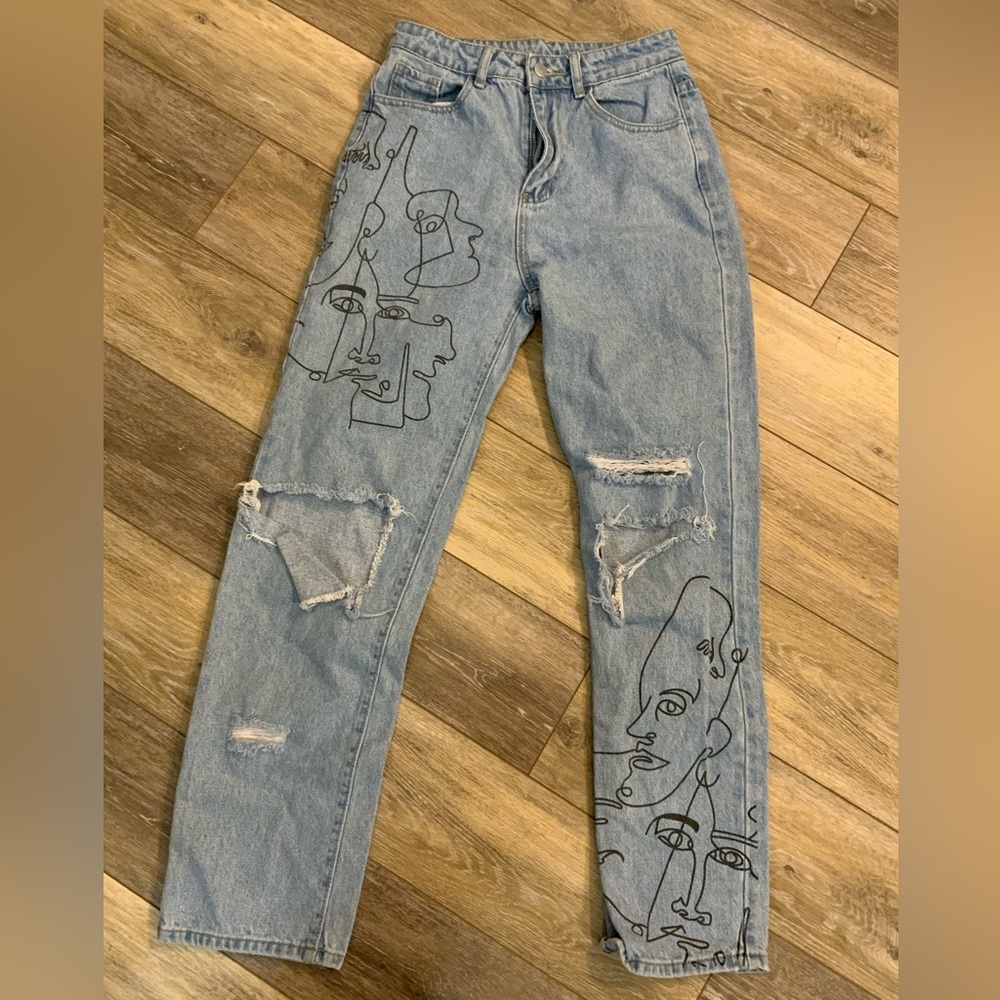 SHEIN distressed jeans with Picasso style faces on front. Size S